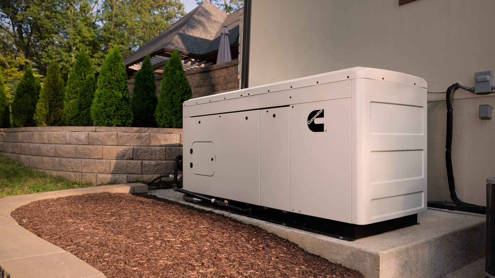 Cummins Connect series liquid-cooled home standby generator on a pad beside a large home